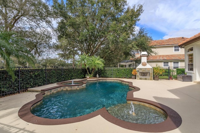 view of pool featuring an outdoor fireplace, a patio area, and an in ground hot tub