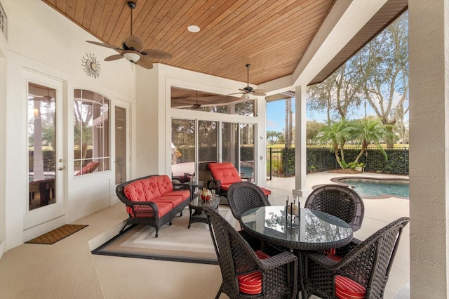 sunroom / solarium featuring ceiling fan, wood ceiling, and a pool