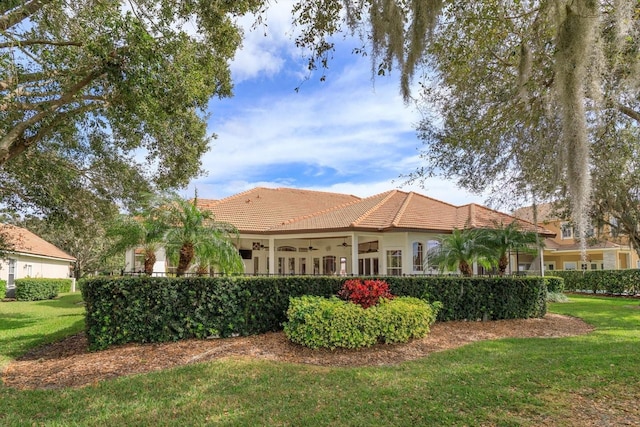 exterior space with a lawn and ceiling fan