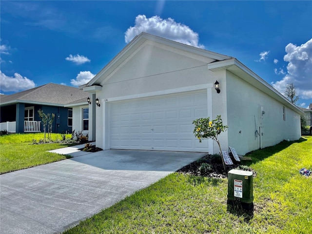 view of front of property featuring a front yard and a garage