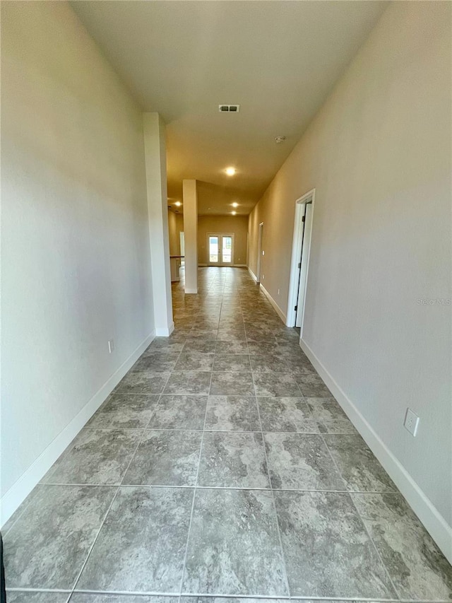 unfurnished room featuring light tile floors