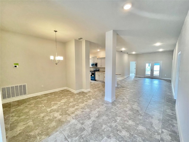 interior space featuring french doors, an inviting chandelier, and light tile flooring