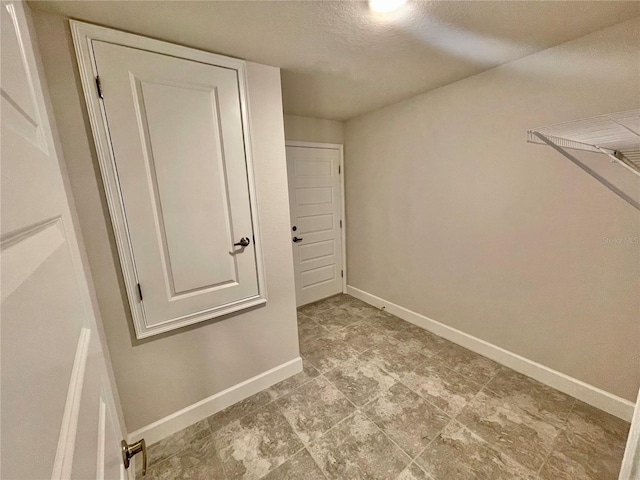 walk in closet with light tile flooring