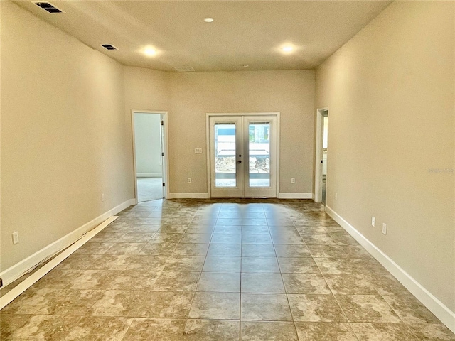 spare room with light tile floors and french doors