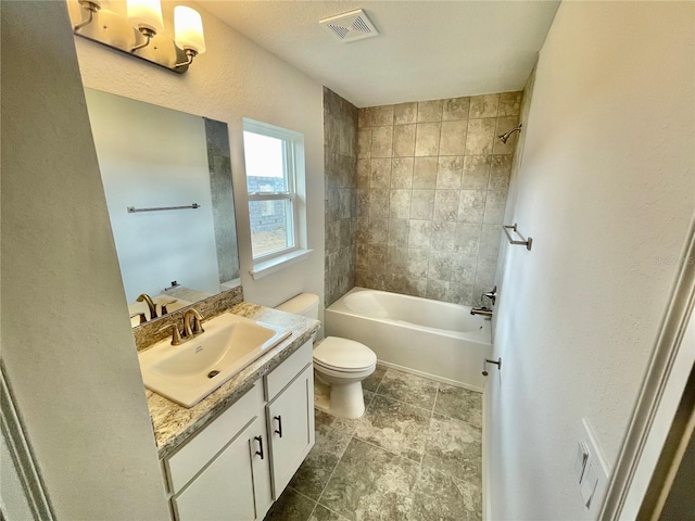 full bathroom featuring tile floors, toilet, vanity, and tiled shower / bath