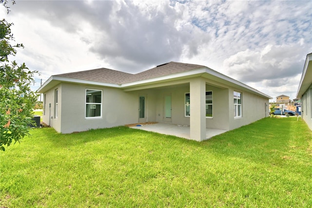 rear view of property with a yard and a patio