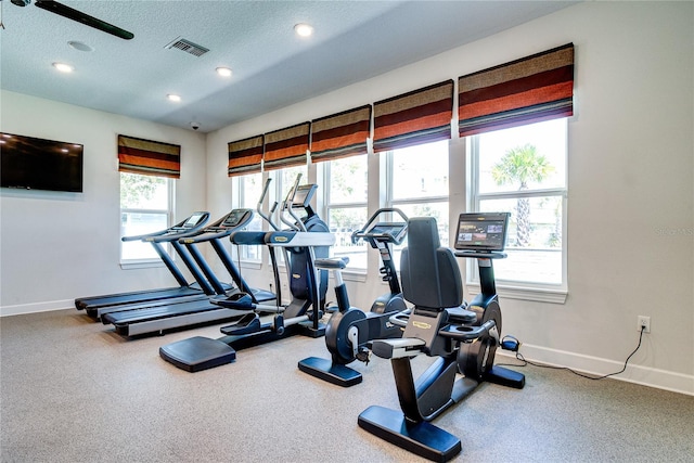 exercise room with a textured ceiling