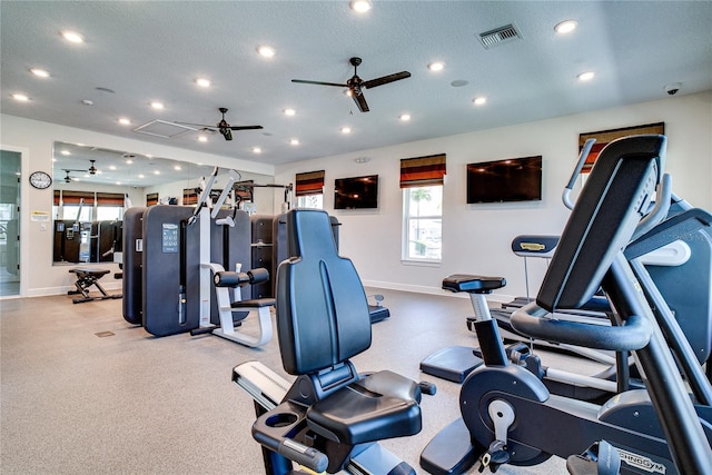 gym with ceiling fan and a textured ceiling