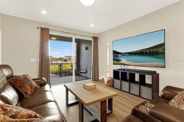 living room with a water view and light wood-type flooring