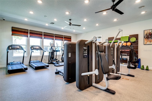 gym with a textured ceiling and ceiling fan