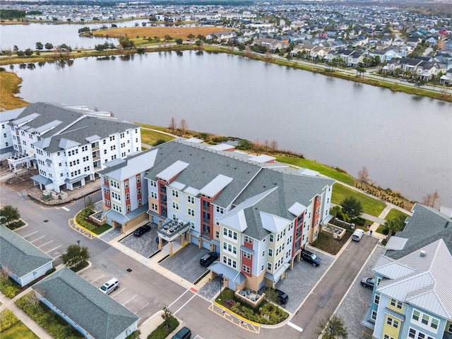 birds eye view of property with a water view