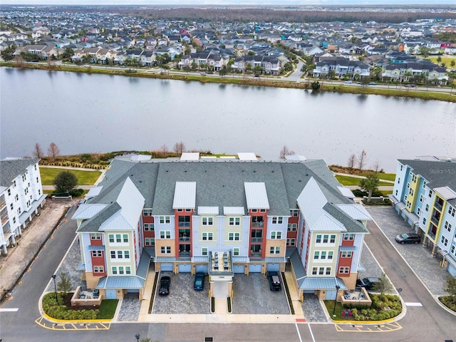 birds eye view of property with a water view