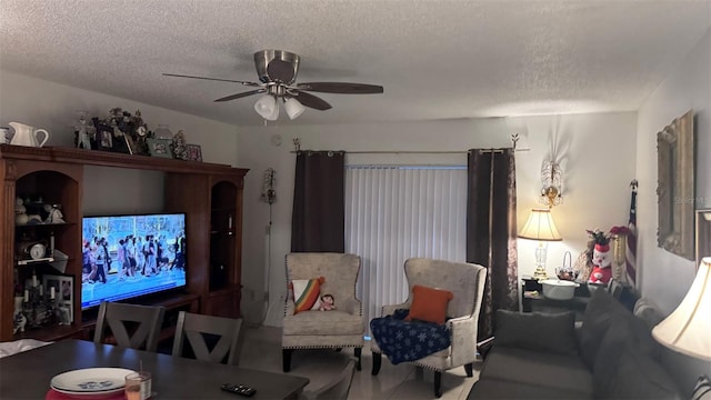 living room featuring a textured ceiling and ceiling fan