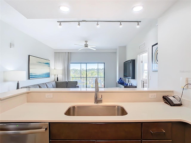 kitchen featuring rail lighting, sink, ceiling fan, and dishwasher