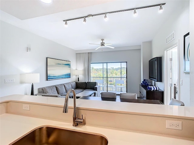 kitchen featuring ceiling fan, rail lighting, and sink