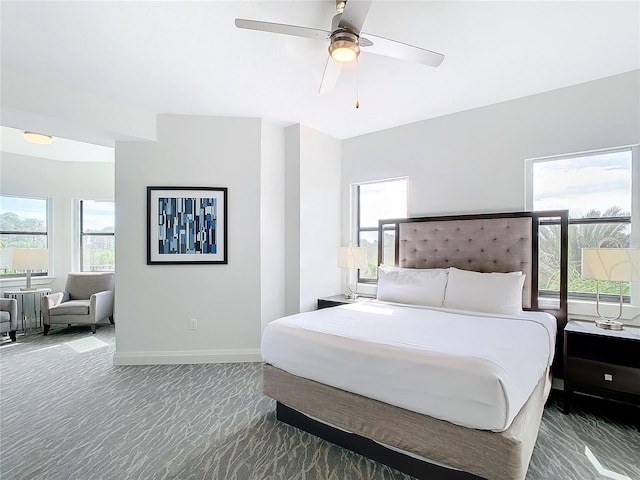 bedroom with dark carpet and ceiling fan