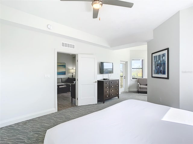 bedroom featuring ceiling fan and dark colored carpet