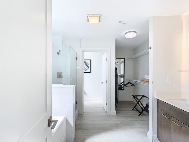 bathroom with independent shower and bath and vanity