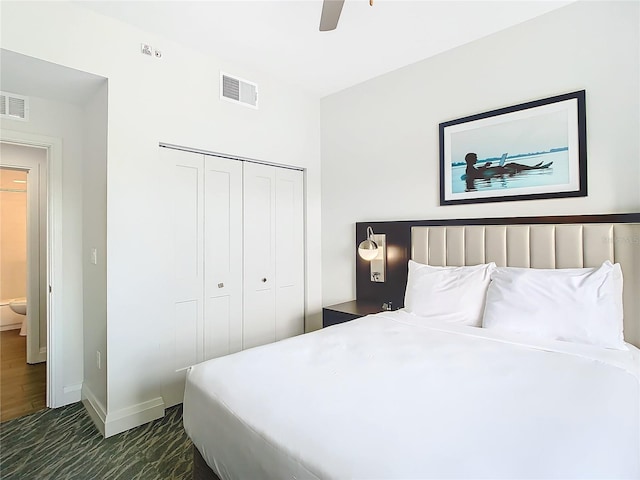 bedroom with a closet, ceiling fan, and dark hardwood / wood-style flooring