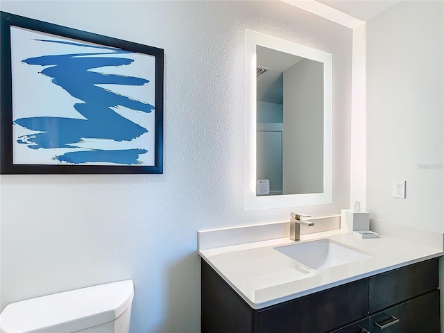 bathroom featuring toilet and vanity