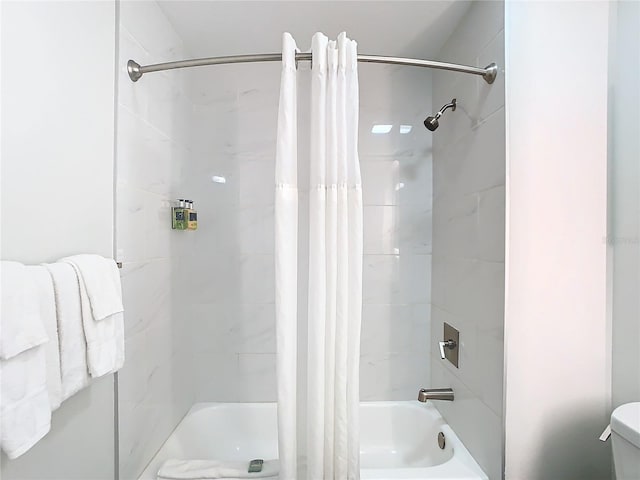 bathroom with shower / bath combo and toilet