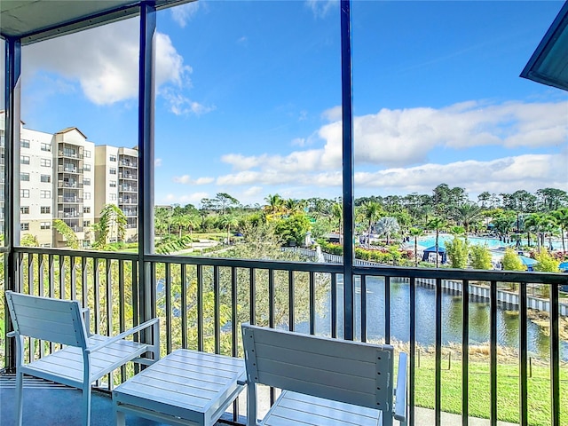 unfurnished sunroom featuring a water view