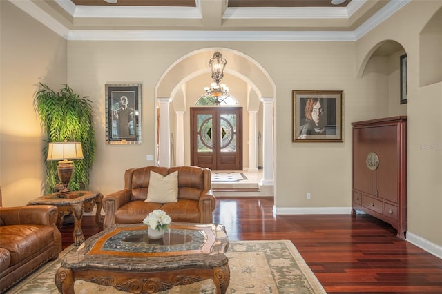 living room with dark hardwood / wood-style floors, a notable chandelier, crown molding, and coffered ceiling