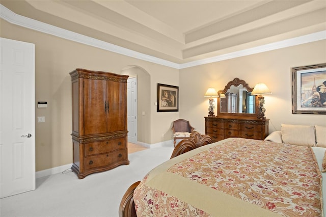 bedroom featuring light carpet, baseboards, arched walkways, and a raised ceiling