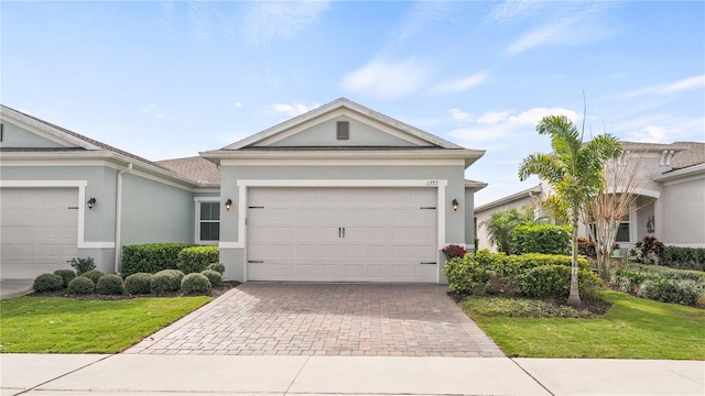 single story home featuring a front yard and a garage