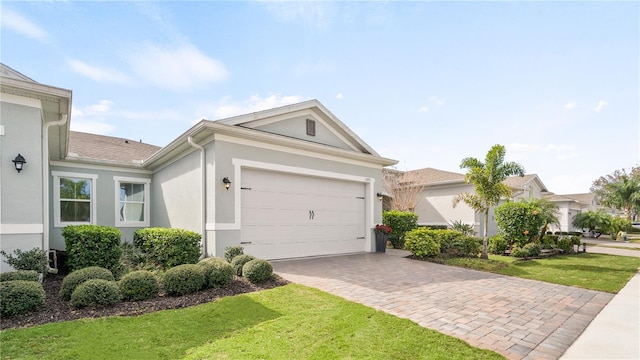 ranch-style house featuring a front lawn and a garage