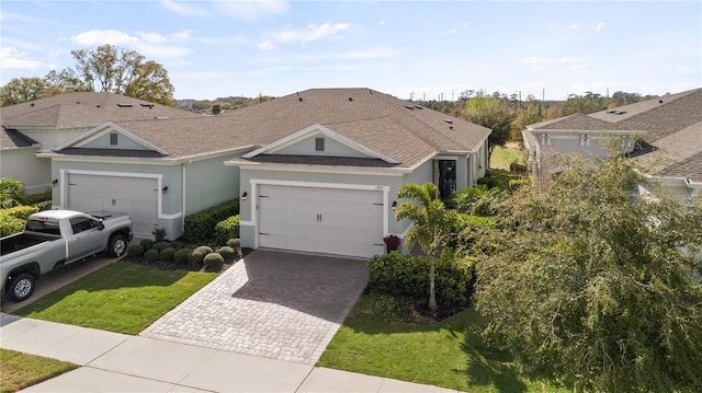 single story home featuring a front yard and a garage