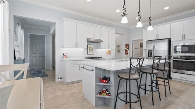 kitchen featuring white cabinets, a center island with sink, and stainless steel appliances