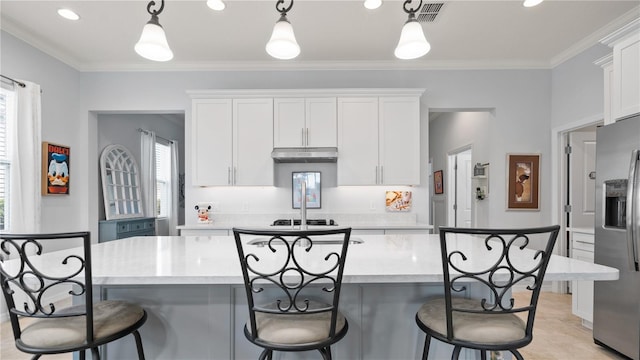 kitchen with a healthy amount of sunlight, hanging light fixtures, and a center island