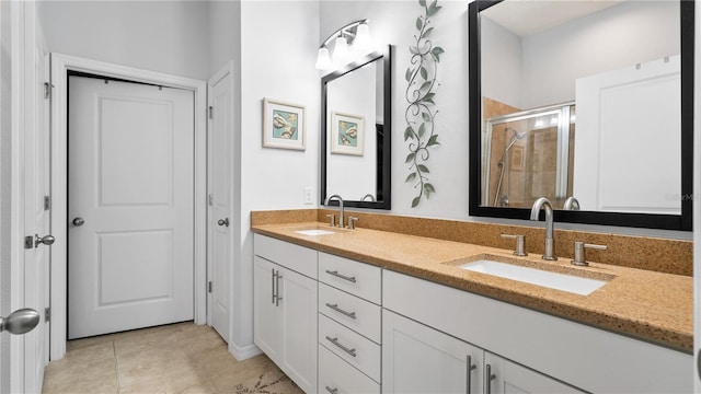 bathroom featuring oversized vanity, tile floors, and dual sinks