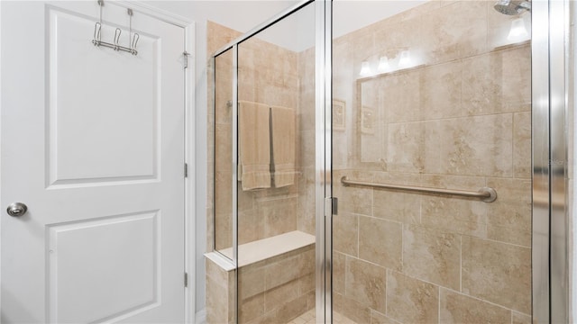 bathroom with a shower with door