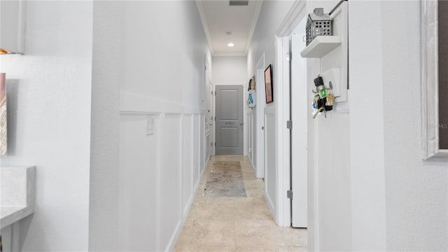 corridor featuring light tile flooring and ornamental molding