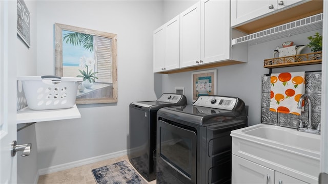 laundry room with light tile flooring, cabinets, separate washer and dryer, and hookup for a washing machine