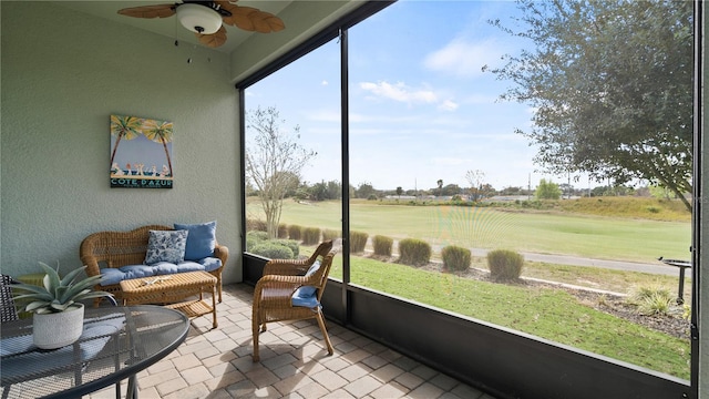 sunroom featuring ceiling fan