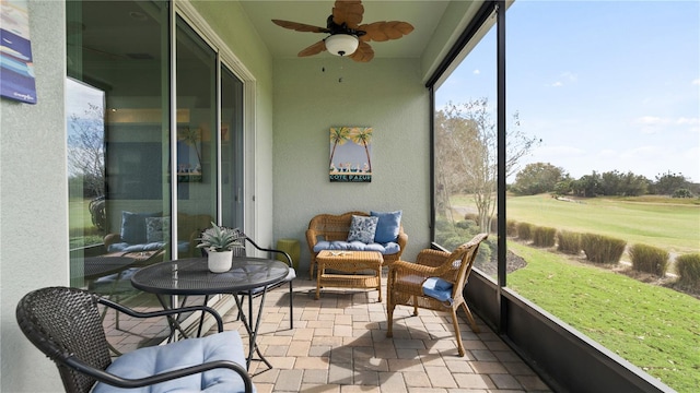 sunroom / solarium featuring ceiling fan