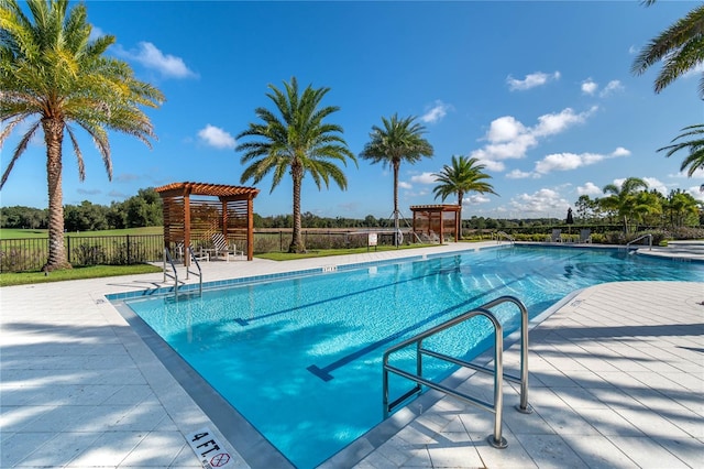 view of pool with a pergola and a patio area