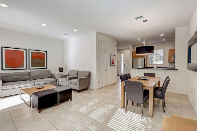 dining space with light tile floors