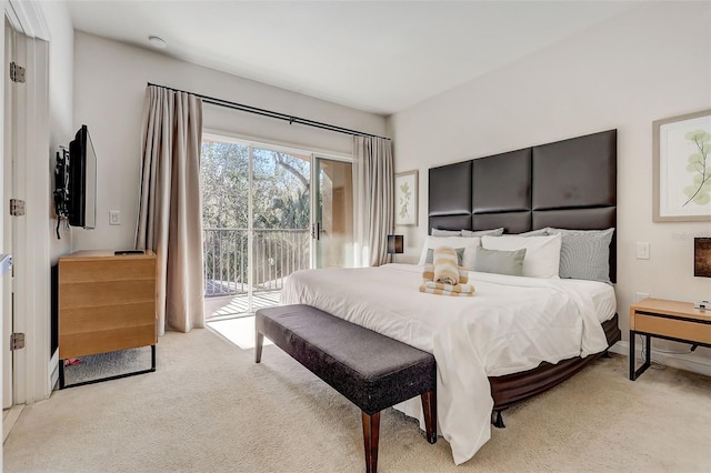 bedroom with access to outside and light colored carpet