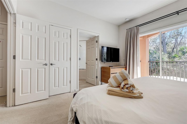 carpeted bedroom with access to outside and ensuite bath