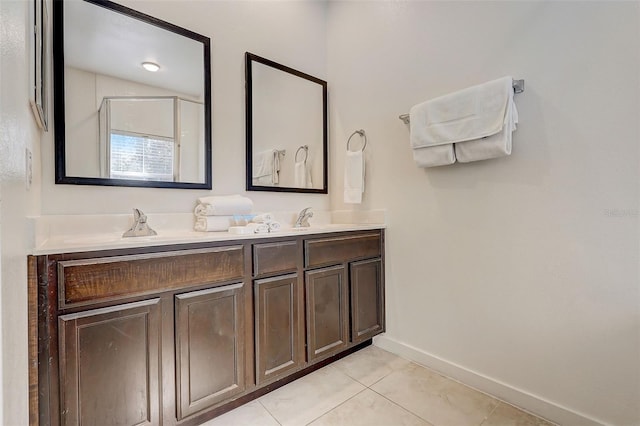 bathroom featuring lofted ceiling, dual vanity, and tile flooring