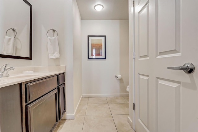 bathroom featuring vanity, tile floors, and toilet