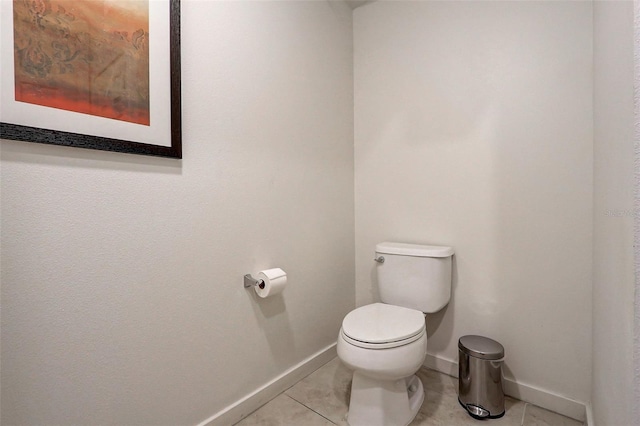 bathroom with toilet and tile floors