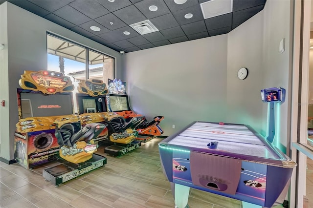 recreation room featuring a paneled ceiling