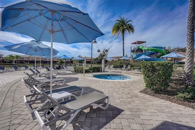 view of swimming pool featuring a community hot tub and a patio