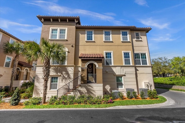 mediterranean / spanish-style home featuring central air condition unit