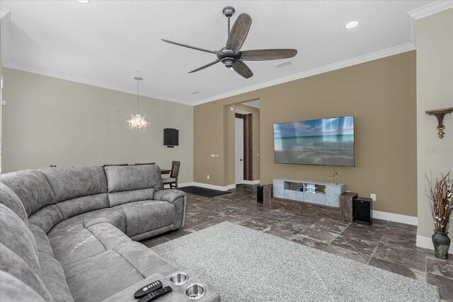 living room with dark tile flooring, ornamental molding, and ceiling fan with notable chandelier